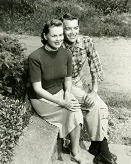 Open Air Prints: Couple sitting on wall in park, (B&W), (Portrait), (Elevated view)