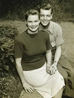 Wavy Hair Prints: Couple sitting on wall in park, (B&W), (Portrait)