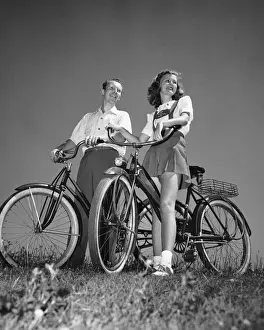 Couple standing with bicycles