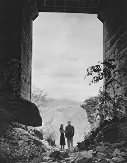 Huge Prints: Couple standing in gate, looking at view, (B&W)