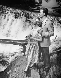 Couple standing near waterfall