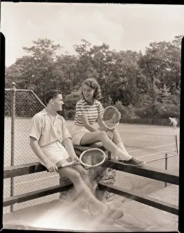 Couple Taking a Break from Tennis