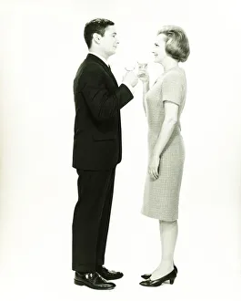 35 39 Years Collection: Couple toasting in studio, (B&W)