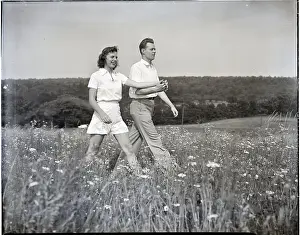 Wildflowers Prints: Couple Walking Through Flower Field