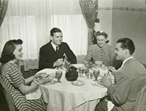 Two couples having dinner, (B&W)