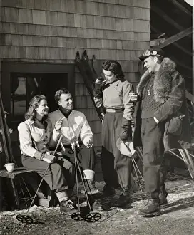 Two couples outside ski lodge