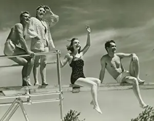 Springboard Prints: Two couples on springboard, (B&W), low angle view