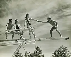 Bending Down Prints: Two couples on springboard, (B&W), low angle view