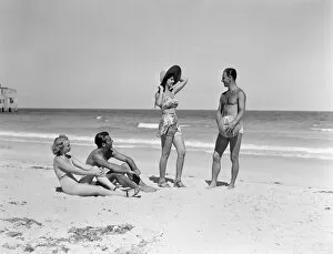 Small Group Of People Gallery: Two couples standing on beach