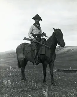 Cowboy on Horseback with Rifle