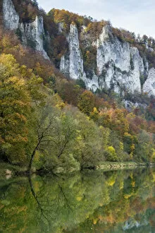 Craggy limestone cliffs with a deciduous forest with autumnal colours in the Danube Valley, Baden-Wuerttemberg, Germany