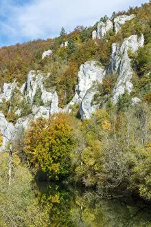 Craggy limestone rocks with a deciduous forest with autumnal colours, Danube Valley, Baden-Wuerttemberg, Germany
