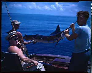 Crew Members Holding Prize Fish