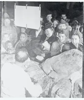 Crowds Looking at Pieces of Meat Through a Store Widow