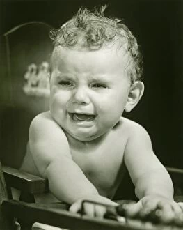 Nostalgia Gallery: Crying baby boy (15-18 months) in baby seat, (B&W), close-up