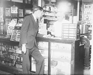 Counter Prints: Customer Standing at Drug Store Counter