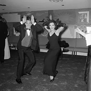 Dancing Couple with Hands at Head