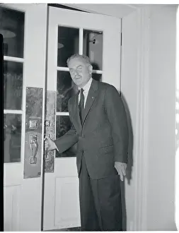 Darryl Francis Zanuck Prints: Darryl Zanuck Grasping a Door Handle