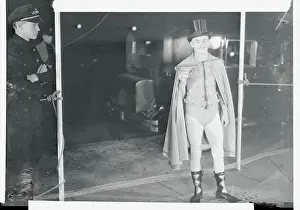 Daryl Zanuck Wearing Caped Outfit near Doorman