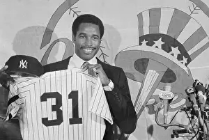 Dave Winfield Holding Shirt and Cap