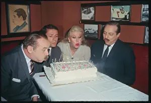 David Merrick and Others Blowing Out Candles
