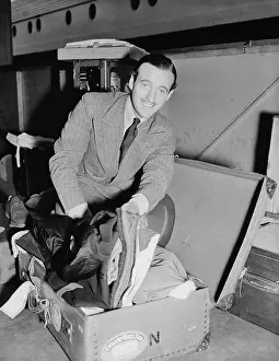 David Niven On Ship with Open Suitcase