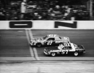 Prints of DAYTONA BEACH, FL - FEBRUARY 20: Buddy Arrington in the #67 Plymouth and David Ray Boggs in the #57 Dodge race during the 1972 Daytona 500 on February 20 Chasing Speed: Motorsport in Motion: Daytona 500