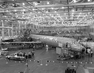 Prints of General view of a DC-9 Super 80 twin-jet in its final assembly with the nose and tail sections joined to fuselage and Pratt and Whitney engines attached, Long Beach, California, May 1980 Timeless Moments: A Visual Journey Through History’s Defining Images: DC-9 Super 80 Production
