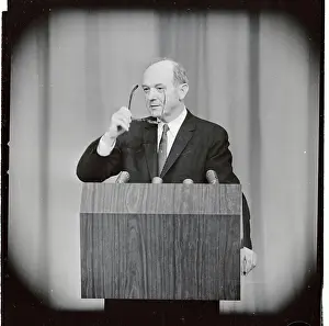 Dean Rusk Holding Eyeglasses at Podium