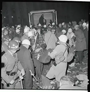 Demonstrator Being Carried to Van