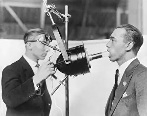 Exhibition Prints: Dentist Demonstrating Artificial Sunlight Lamp on Patient
