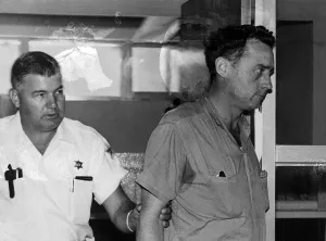 Leading Prints: Deputies Lead Away Murder Suspect