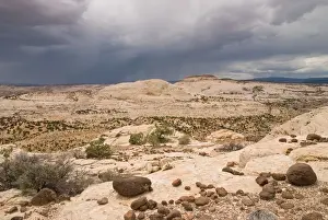 Desert Storm With Lava Boulders In The Foreground At Grand Staircase-Escalante National Monument