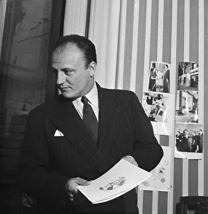 Designer Pierre Balmain Holding Book