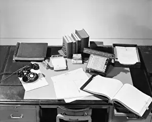 Ledger Prints: Desk Covered with Assorted Office Supplies