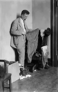 Investigator Prints: Detective Examining Clothing of Murder Victims