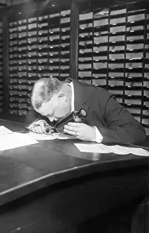 Investigating Prints: Detective Faurot Examining Fingerprints