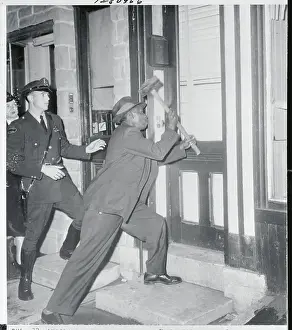 Detective Smashing Door with Sledge Hammer