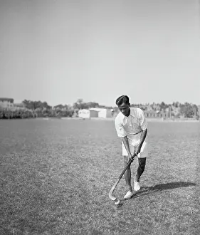 Prints of (Original Caption). Greatest Hockey Player of 1928 Olympics, Again Playing for India Frozen Moments: A Journey Through Hockey History: Dhyan Chand Practicing