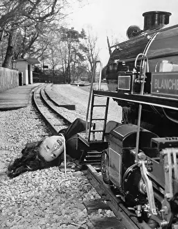 Diana Rigg Tied to Miniature Train Tracks