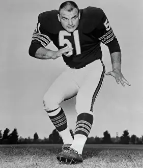 Dick Butkus in Kicking Position on Football Field