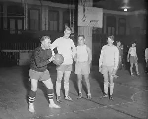 Prints of (Original Caption). The basketball season opened Nov. 16 at Columbia University with the squad showing up for first practice and an examination of the material on hand Hoops Through Time: A Visual Journey of Basketball History: Dick Meenan Instructing Members of His Team