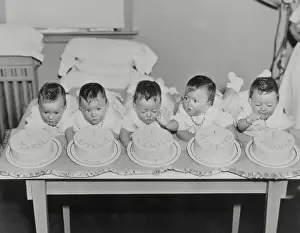 Birthday Prints: Dionne Quintuplets Blowing out Candles on Their Birthday Cakes