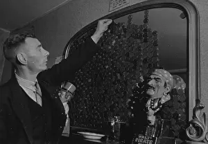 Prints of circa 1941: The King William Inn in Tunley contributes to war charities by encouraging customers to dip a penny in beer and then stick it on a mirror Discover the Vision of Haywood Magee – A Master of Mid-Century British Life: Dip A Penny