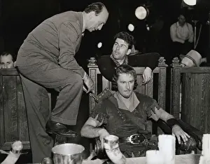 Director Preparing Actor Errol Flynn for Movie Scene
