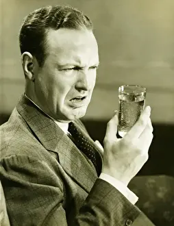40 49 Years Prints: Disgusted man looking at glass of water, (B&W)