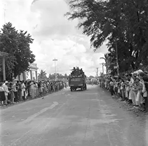 Distant View of Fidel Castro Riding on Truck with Soldiers