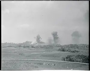 Distant View of Smoking Land Areas Under Bomb Attack