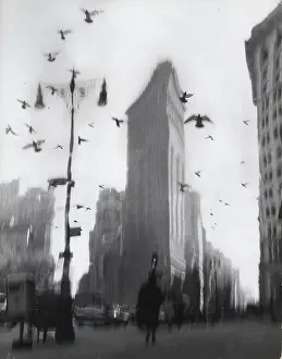 Prints of New York, NY - JANUARY 1959: A distorted photo montage of birds flying over the Flatiron Building at 175 Fifth Avenue and 23rd Street, in 1959 in New York City, New York Portraits, Artworks, and Montages from a Visionary Photographer: Distorted Image of the Flatiron Building in the 1950's