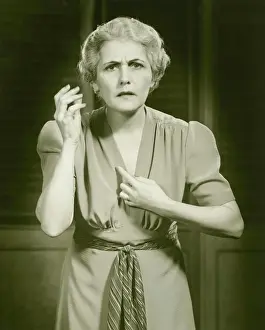 Wavy Hair Prints: Distraught woman gesturing in studio, portrait